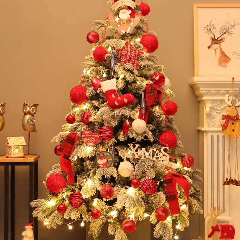 Full view of pre decorated snow flocked Christmas tree