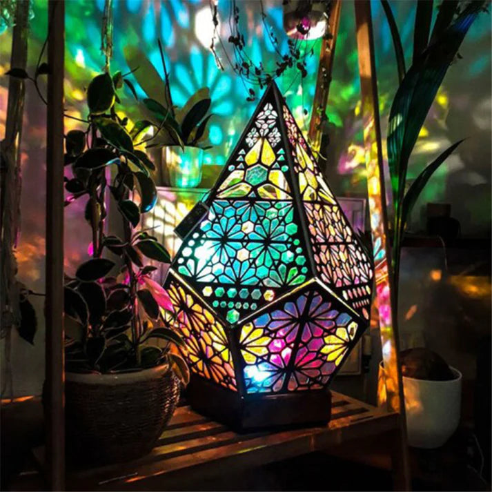 Geometric projection lamp glowing purple in dark room
