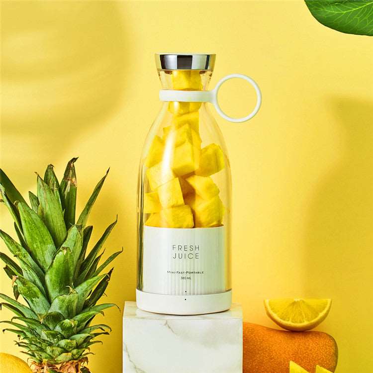 Rechargeable mixer cup with yellow smoothie and plant