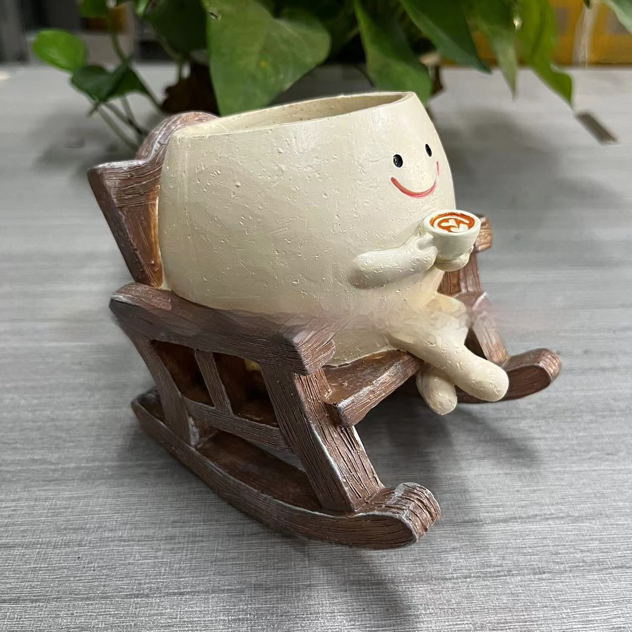 Resin lady rocking chair succulent pot empty close up