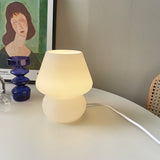 Close-up of the push button switch on the base of the retro glass USB table lamp
