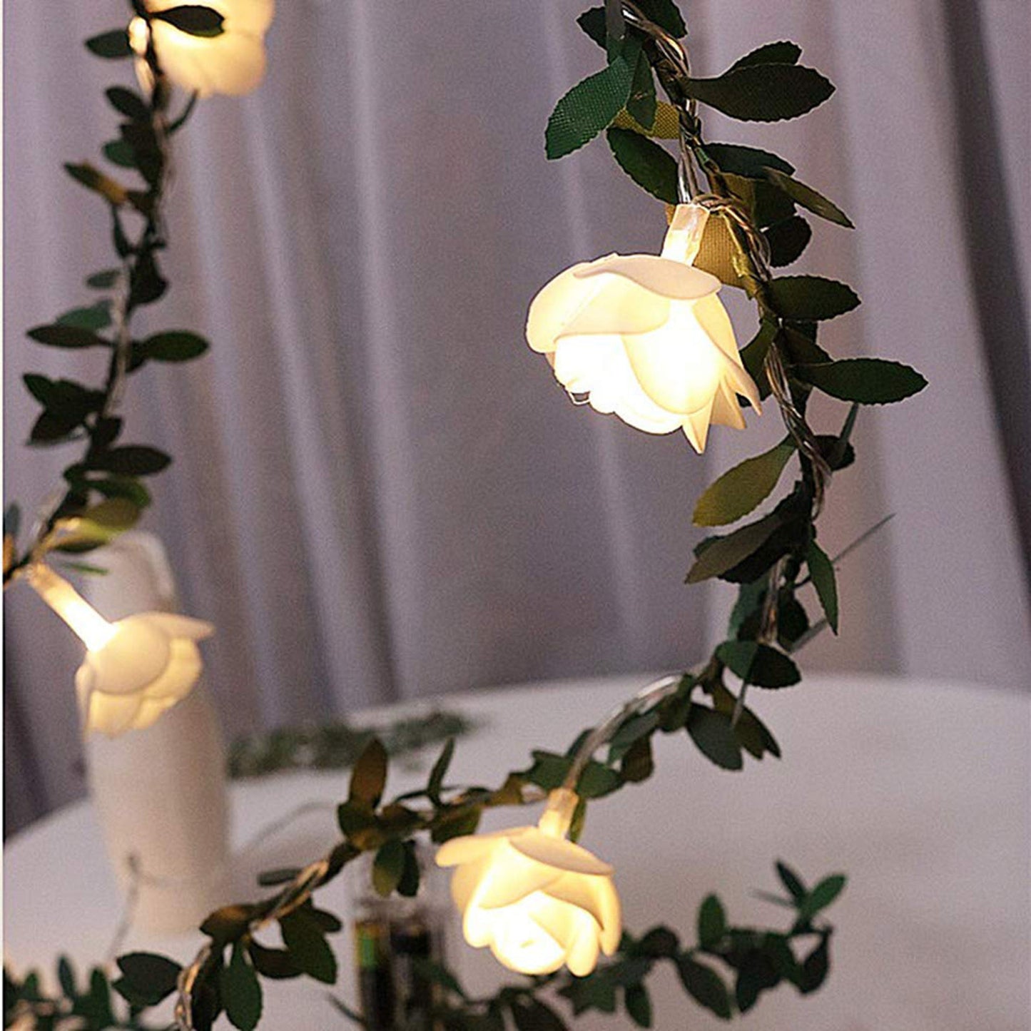 Rose leaf garland fairy lights used as wall decor