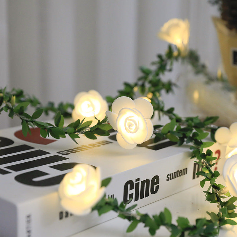 Rose vine LED string lights draped on shelf for home decor