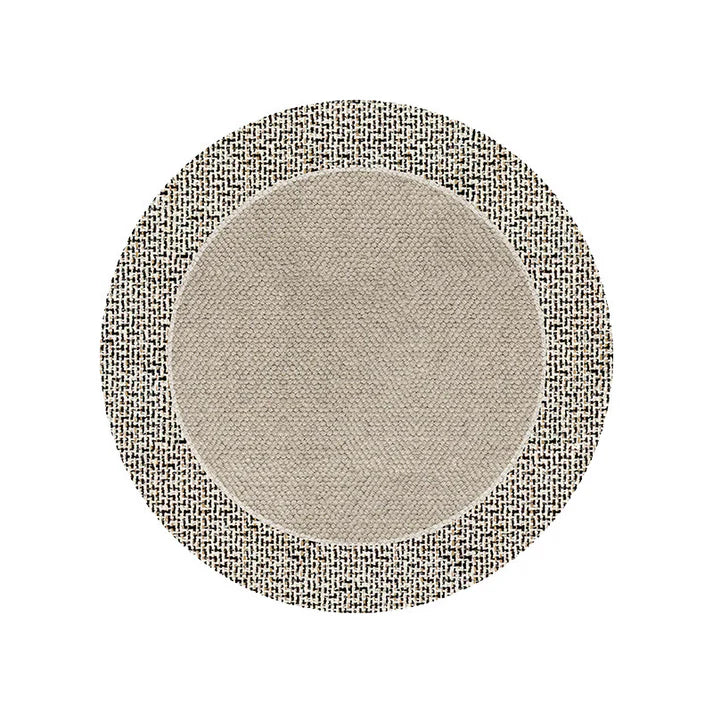 Round carpet in warm room color placed in cozy bedroom near sofa and tea table