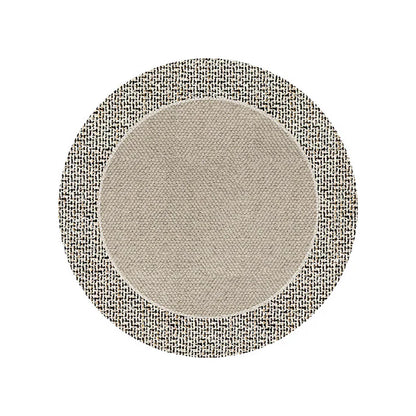 Round carpet in warm room color placed in cozy bedroom near sofa and tea table