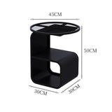 Round tempered glass side table holding multiple items showing 15kg weight capacity in use
