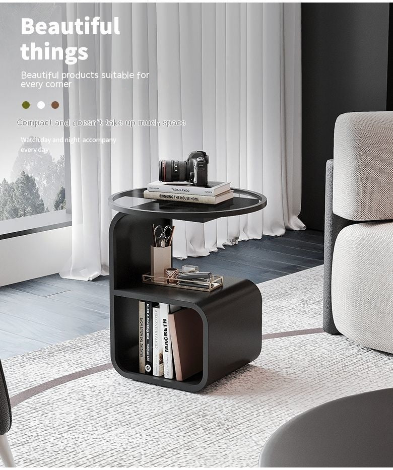 Close-up of the smooth tempered glass top surface on the round metal sofa side table
