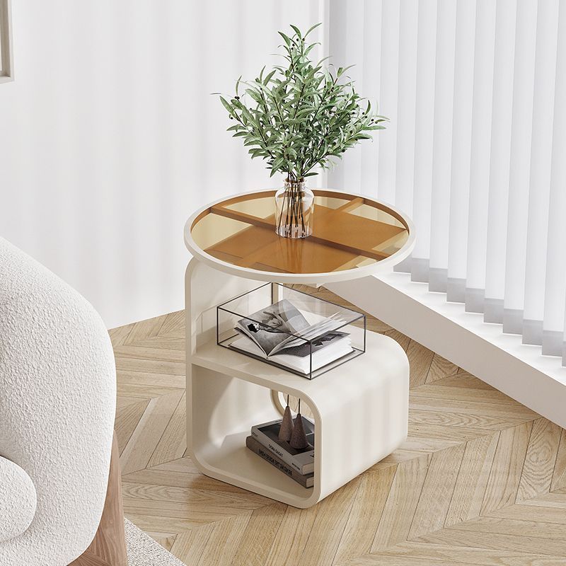 White metal frame round tempered glass sofa side table beside a sofa in a modern living room
