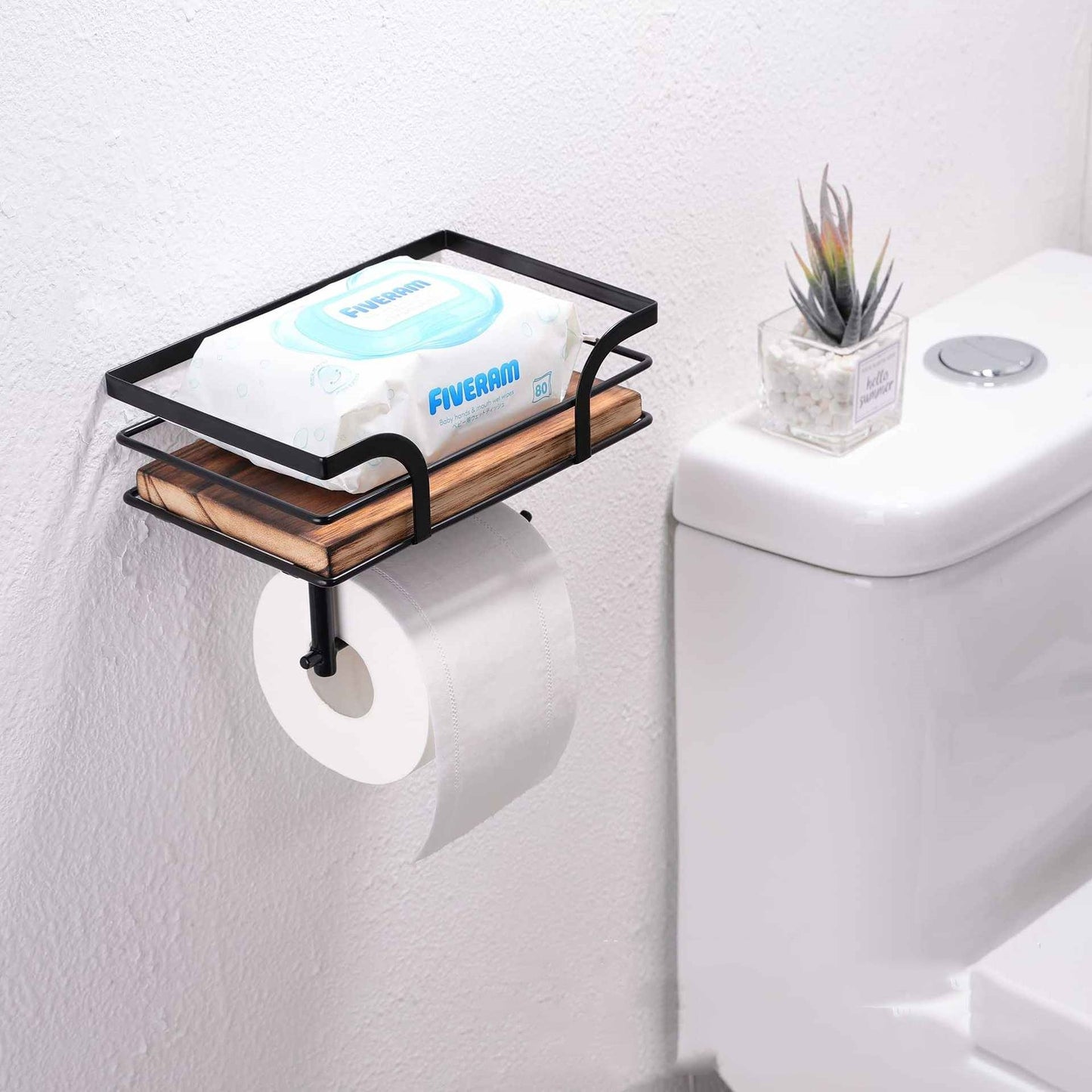 Farmhouse wood and iron toilet paper holder on a bathroom counter beside a sink
