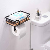Farmhouse wood and iron toilet paper holder on a bathroom counter beside a sink