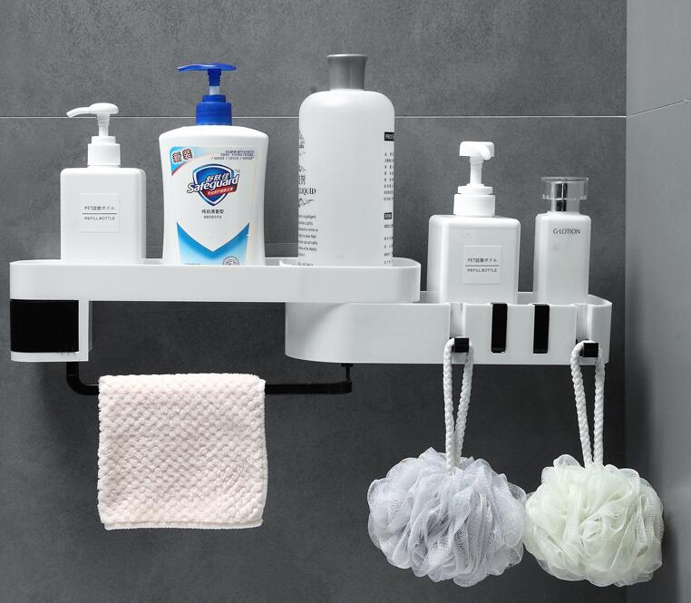 White rotating shower shelf holding shampoo and soap bottles