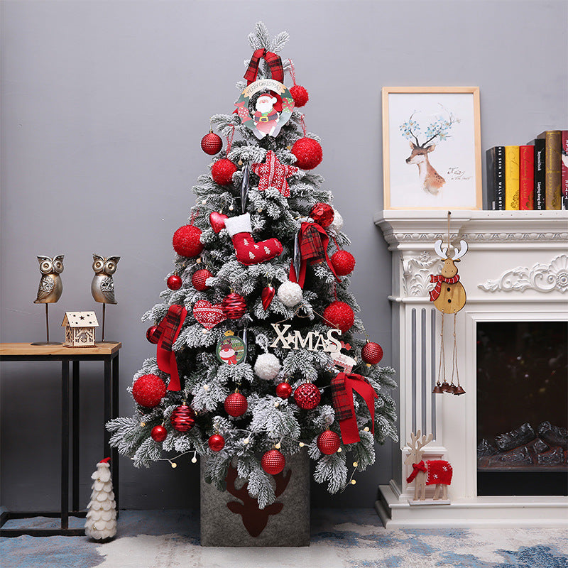 Snow flocked Christmas tree with red ornaments