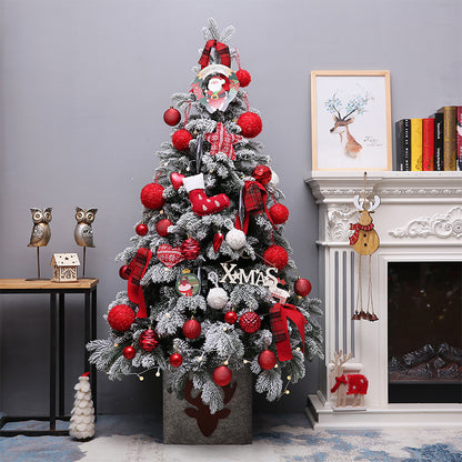 Snow flocked Christmas tree with red ornaments