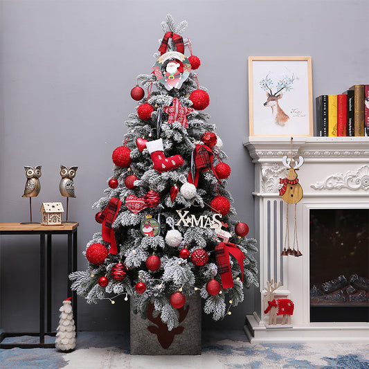 Snow flocked Christmas tree with red ornaments
