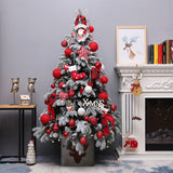 Snow flocked Christmas tree with red ornaments