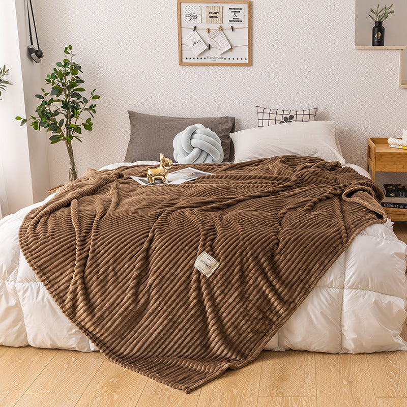 Person wrapped in a soft queen size fleece blanket on a sofa on a cold evening
