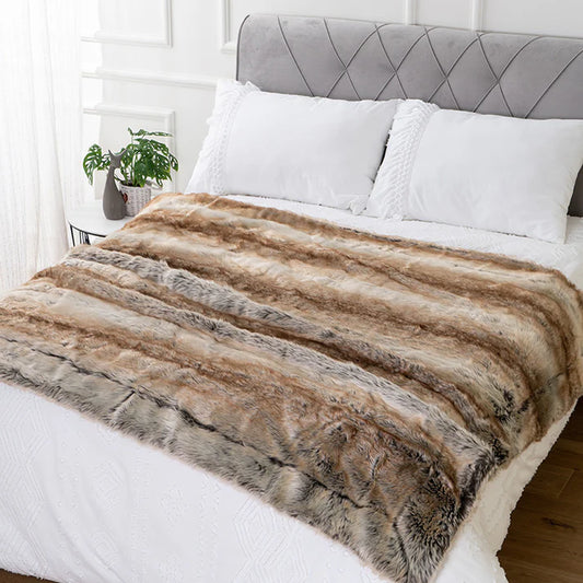Soft plush faux fur throw blanket draped over sofa in cozy living room setting