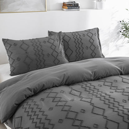 Gray patterned bedding set on a bed with pillows