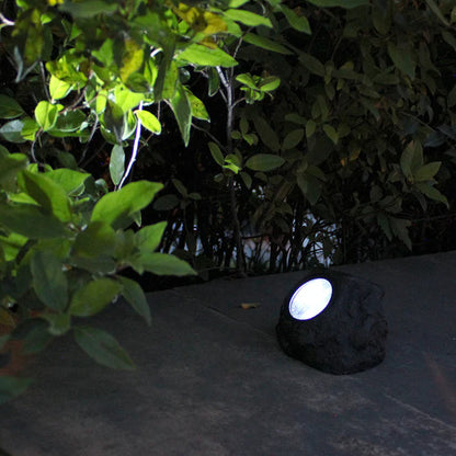 Solar rock garden light glowing white LED at night