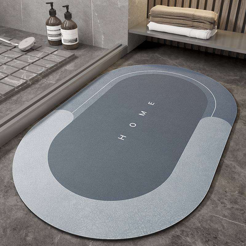 Splendas absorbent non slip blue oval bath mat memory foam microfiber on bathroom floor.