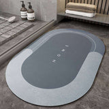 Splendas absorbent non slip blue oval bath mat memory foam microfiber on bathroom floor.