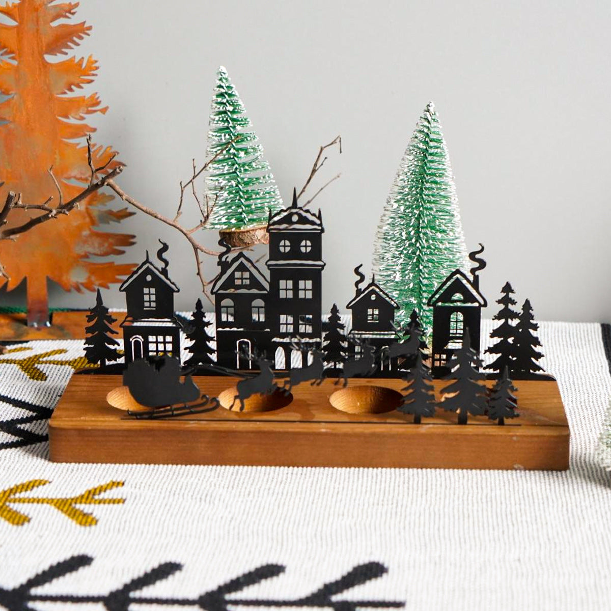 Splendas wrought iron Christmas tree candle holder styled in holiday home decor setting