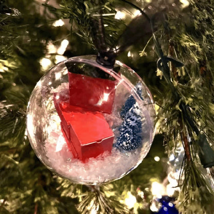Close up detail of Splendas Christmas transparent ball hanging ornament festive scene layout