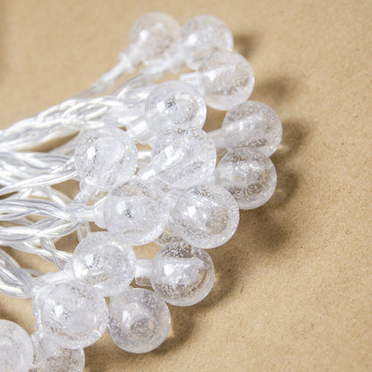Splendas LED colorful crystal ball string lights close up display on wooden surface