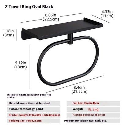 Matte black oval towel ring in a modern bathroom with dark tile and matching black fixtures
