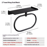 Matte black oval towel ring in a modern bathroom with dark tile and matching black fixtures