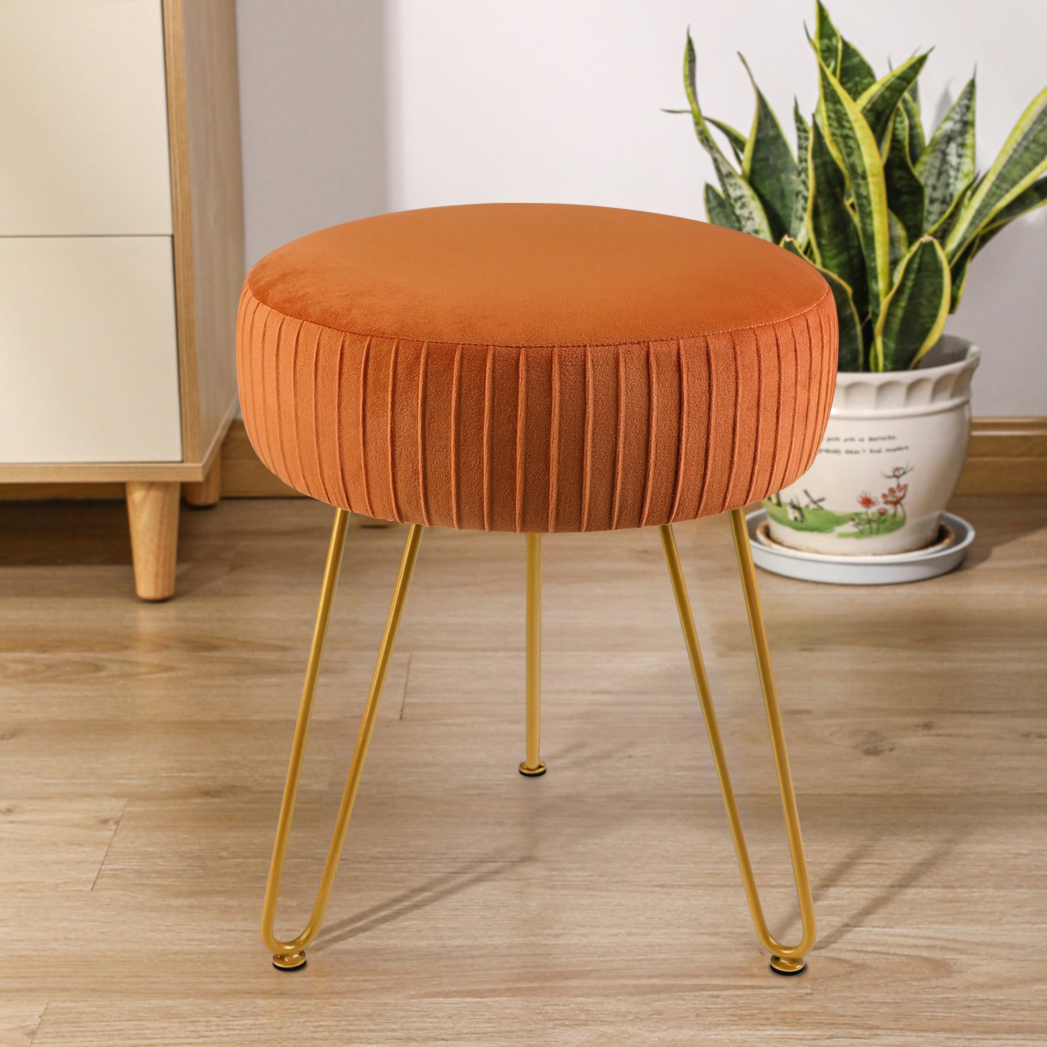 Striped metal footstool placed in front of a dressing table in a modern minimalist bedroom
