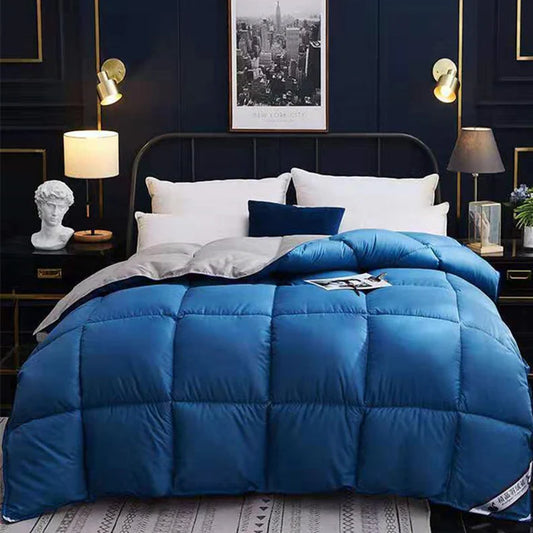 Thick quilted bed duvet in blue on bed in bedroom