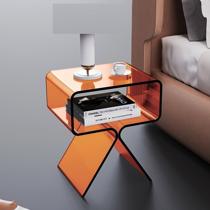 Remote and glass sitting on the transparent acrylic side table creating a floating object effect
