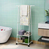 Triangle floor coat rack styled in bedroom with storage boxes