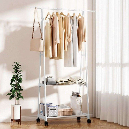 White triangle floor coat rack with clothes hanging and wheels