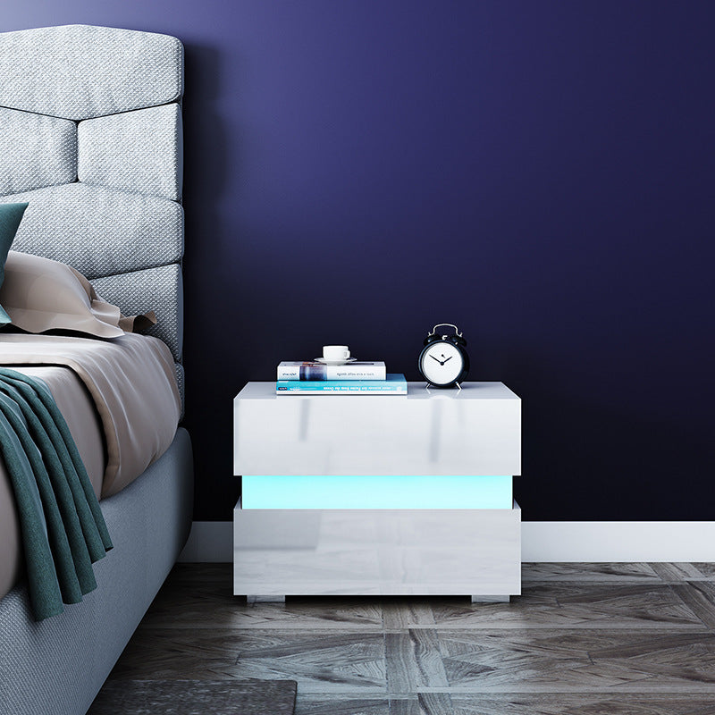 Two drawers of the white minimalist side table open showing spacious storage inside
