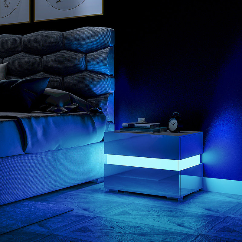 Close-up of the built-in RGB LED light glowing at the base of the white drawer side table
