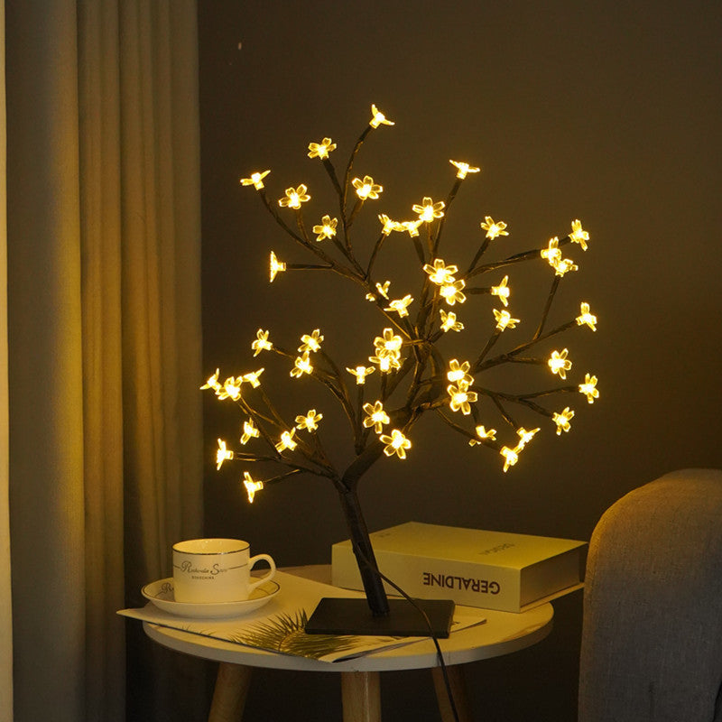 USB cherry tree bonsai lamp glowing in dark room