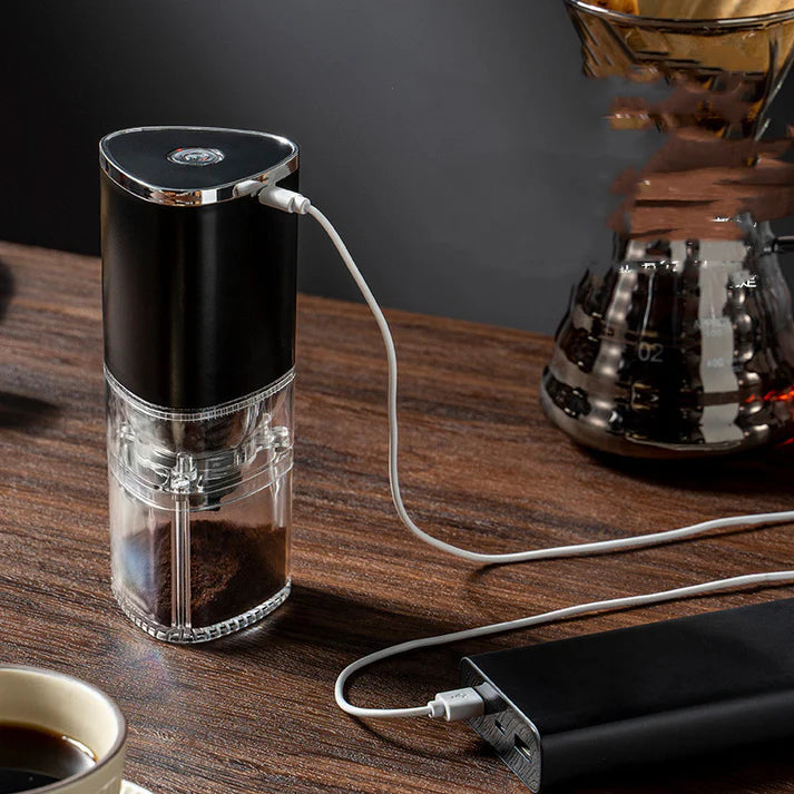 USB electric coffee grinder grinding coffee beans dark background