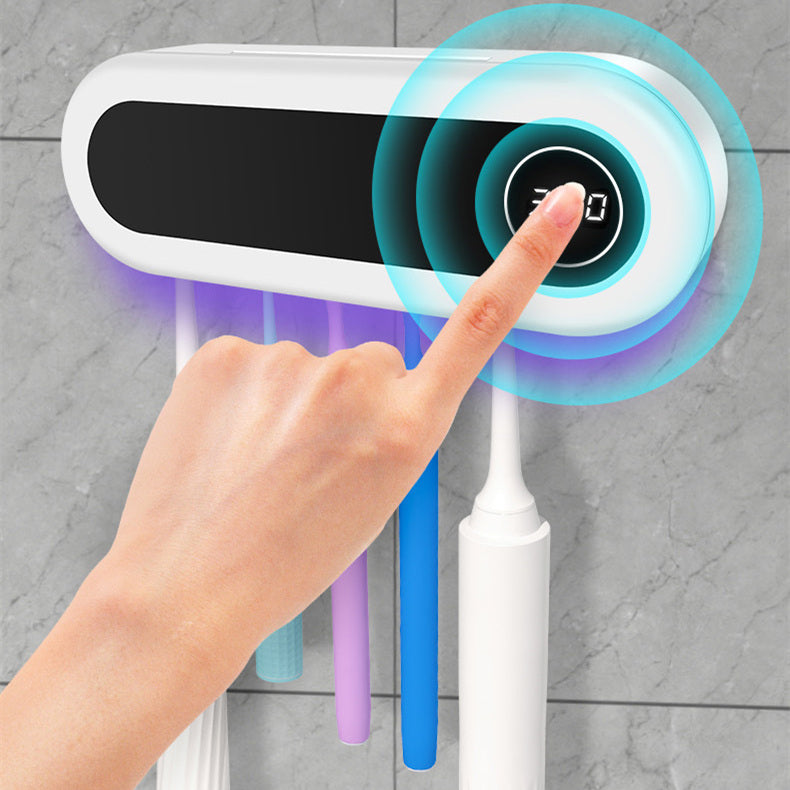 Hand installing UV toothbrush disinfection shelf on wall