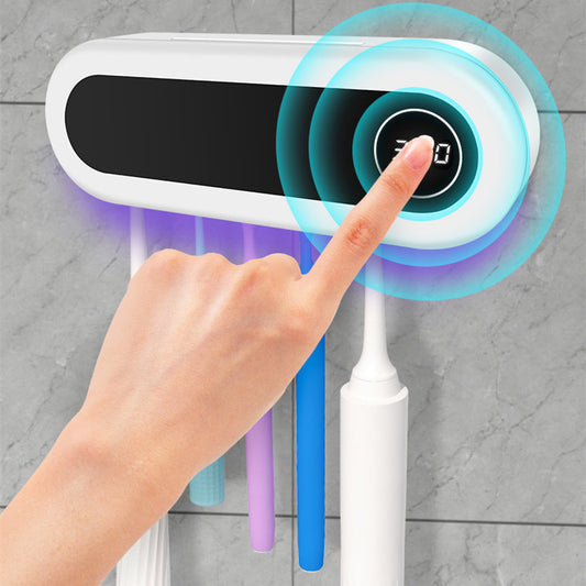 Hand installing UV toothbrush disinfection shelf on wall