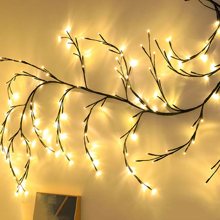 Vine branch LED string lights glowing in dark room