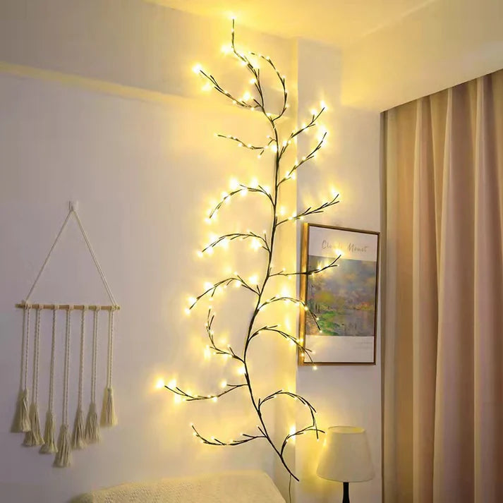 Vine branch LED string lights glowing warm in room corner