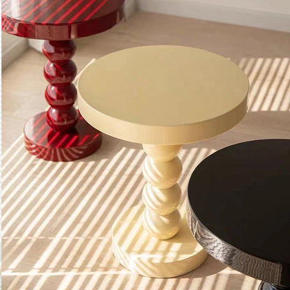 Compact vintage solid wood round table fitting into a narrow bedroom corner without wasted space
