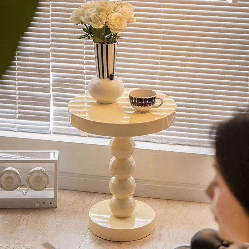Close-up of the tapered vintage-style legs on the solid wood round bedside side table
