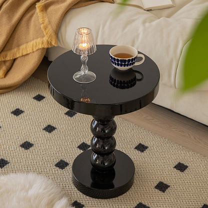 Yellow solid wood round side table as a color accent piece in a mostly white living room
