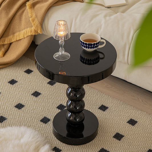 Yellow solid wood round side table as a color accent piece in a mostly white living room
