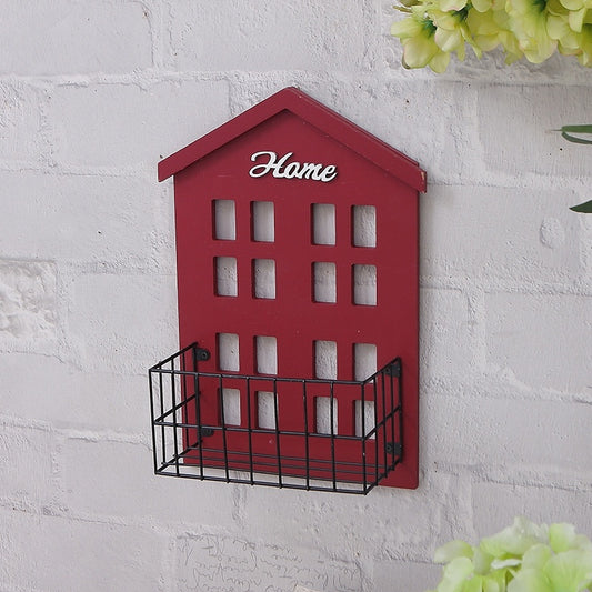 Red double-storey miniature house wall shelf mounted on a white living room wall