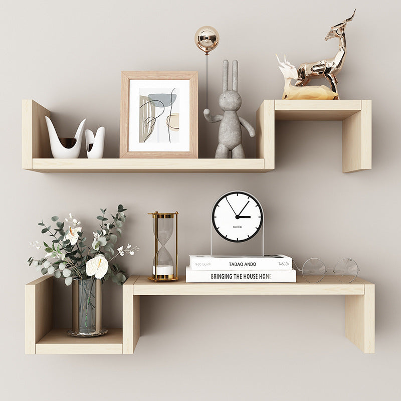 60cm wide wall mounted shelf in wood color holding books and decorative items