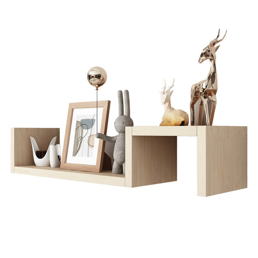 Black double layer wall shelf mounted in a living room with books and a small plant